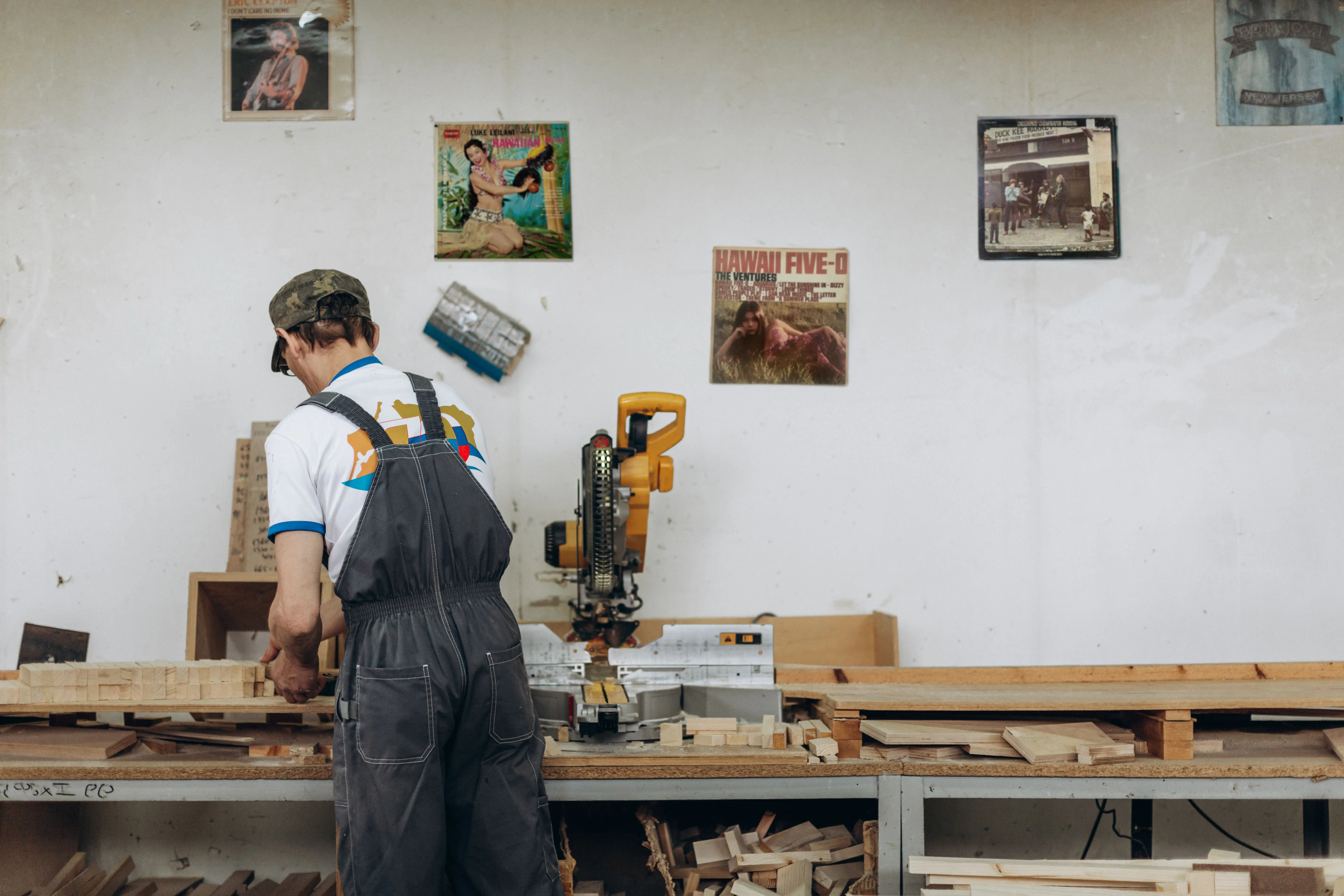 A small business owner working on a laptop in a woodworking shop